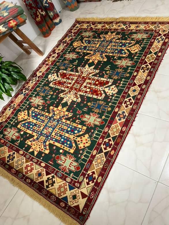 Decorative rug with intricate patterns on a tiled floor