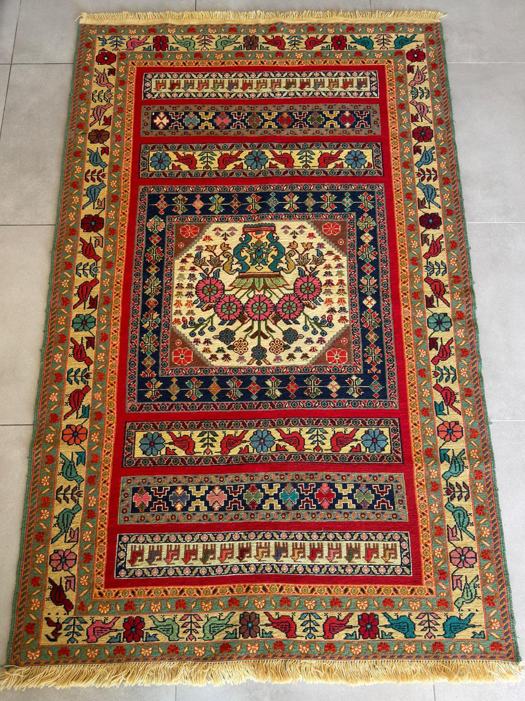 Decorative rug with intricate patterns on a tiled floor