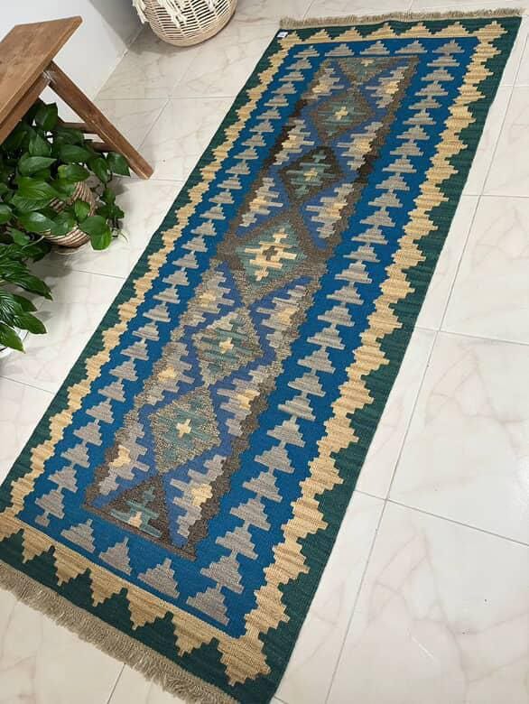 Decorative rug with geometric pattern on a tiled floor
