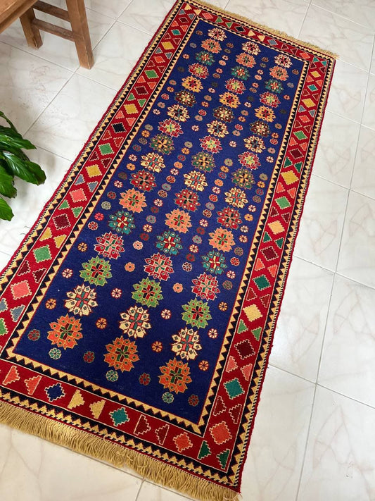 Decorative rug with colorful floral patterns on a tiled floor